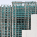 High-density industrial racking system in a large warehouse, showcasing precision-engineered steel storage structures designed for maximum space efficiency and organization. rack claded warehouse